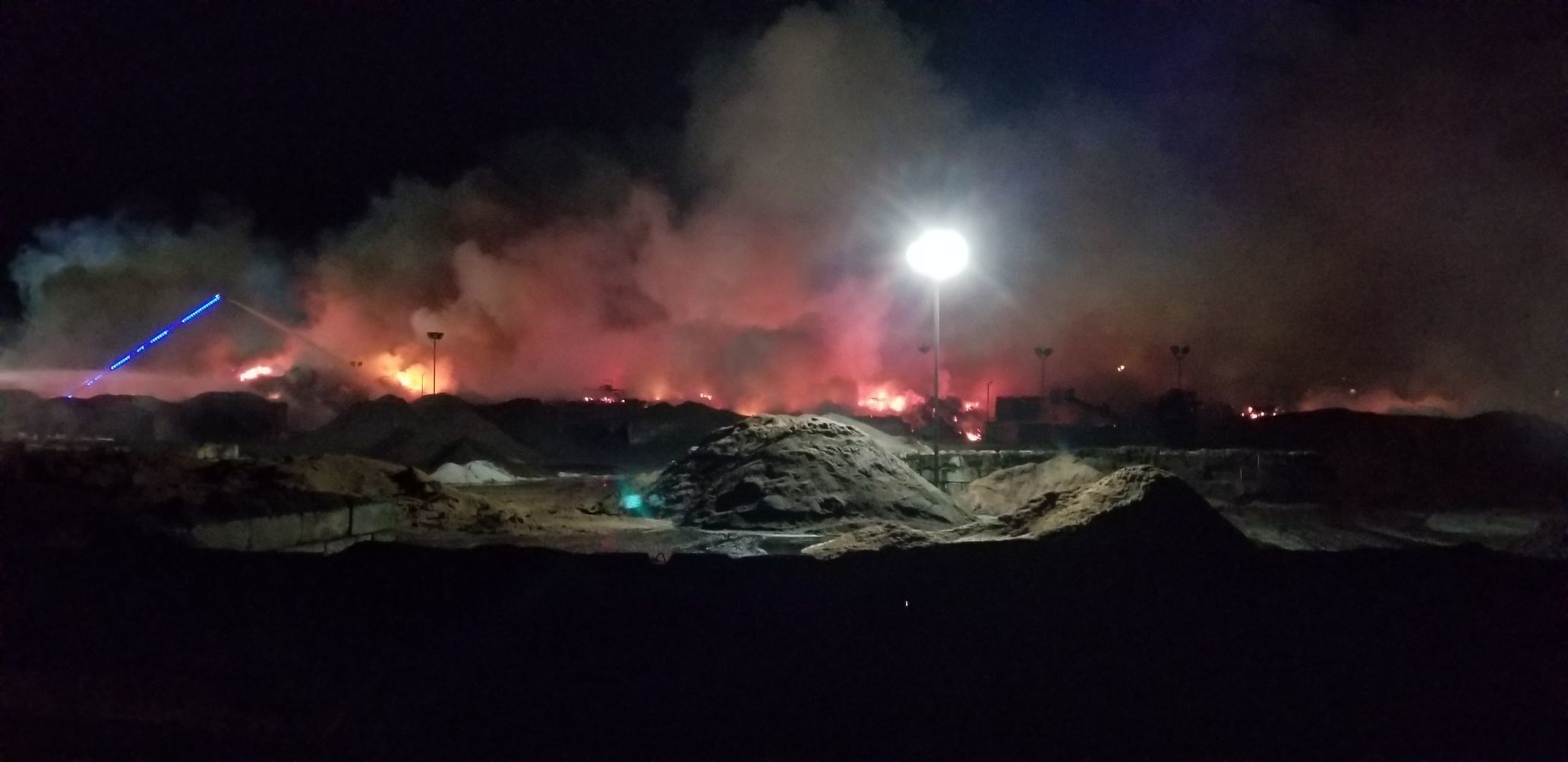 Ladder truck drenches wood piles at Swanson Bark